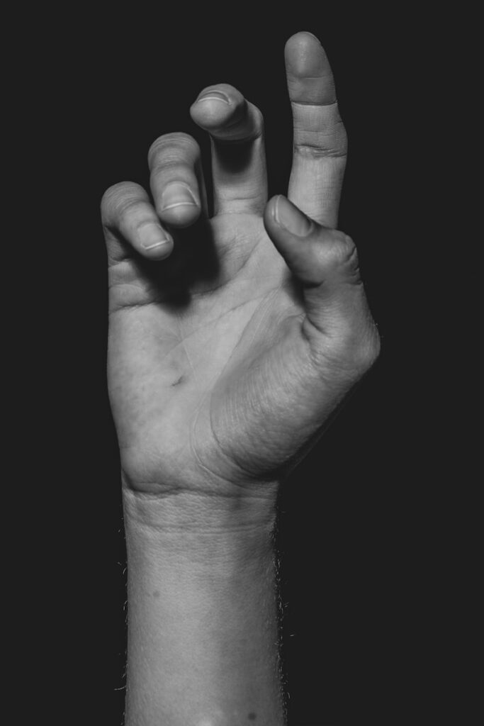 grayscale photo of persons hand