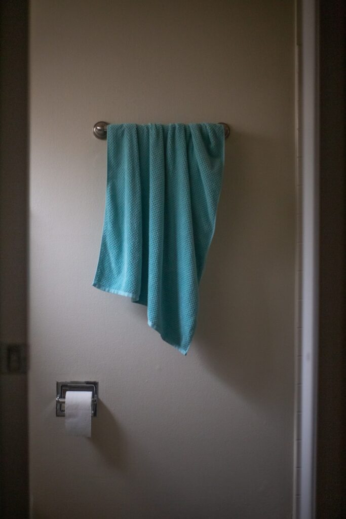 green towel on white wall