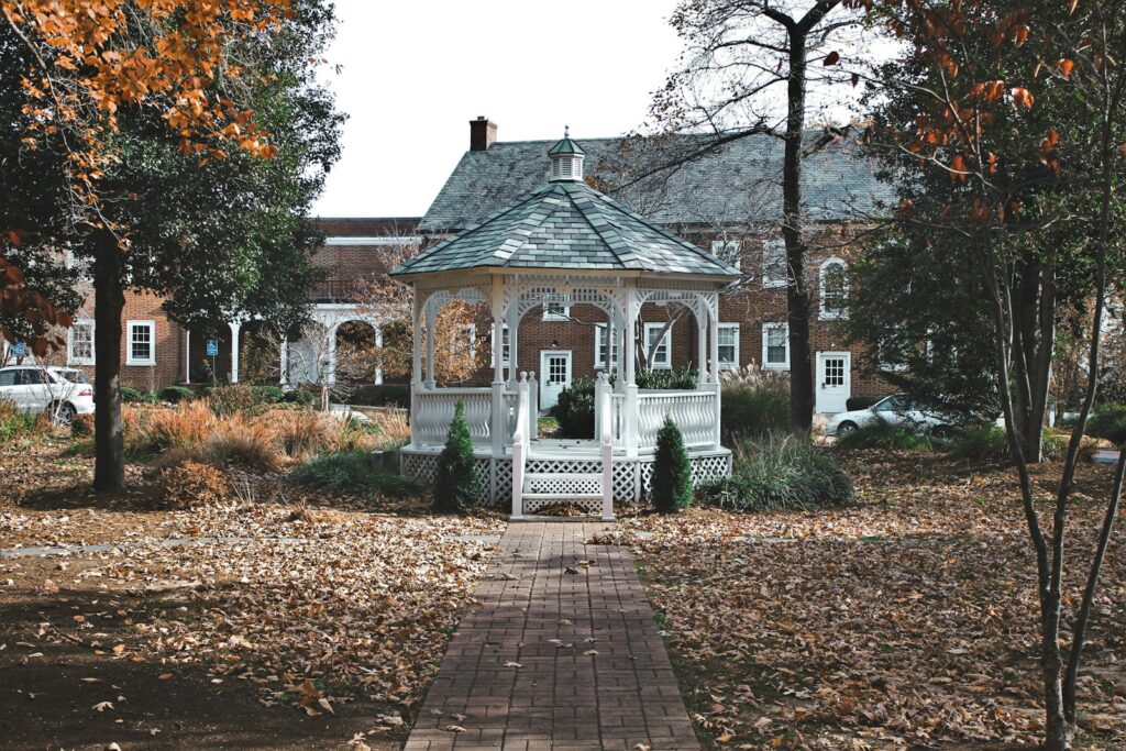 white gazebo in the middle of park during daytime